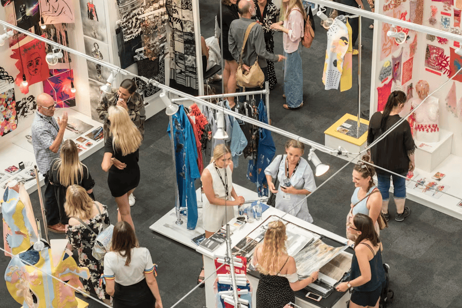 view from up high of lots of people in shop with hanging clothes