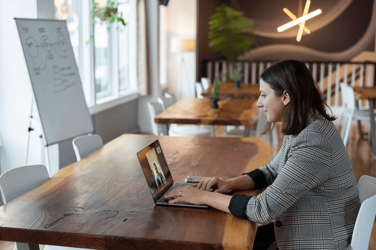 woman sitting at table on laptop