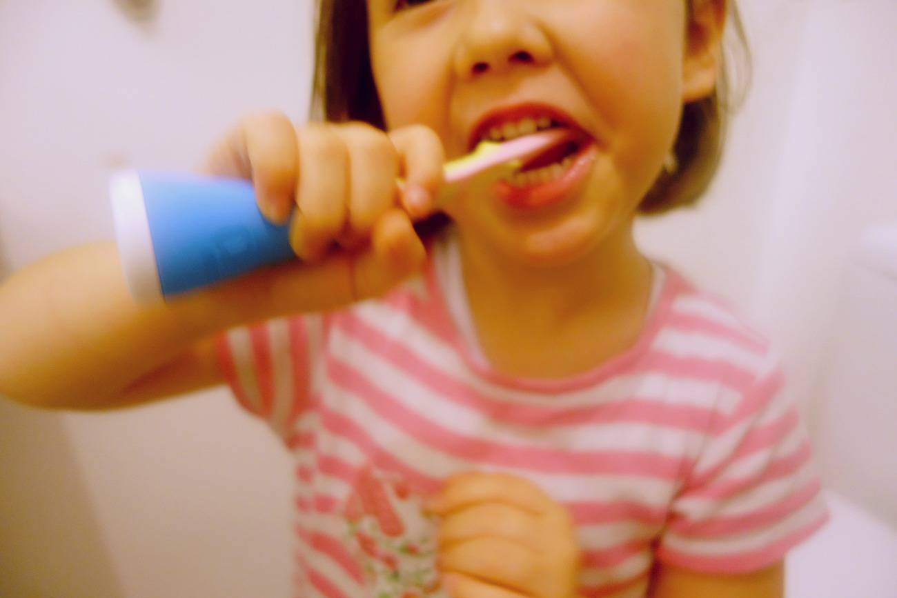 child brushing teeth using playbrush