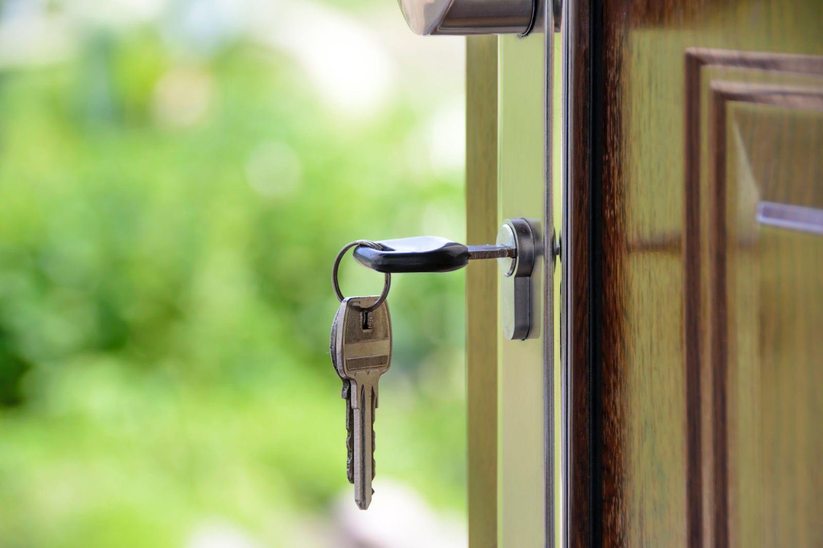 key hanging in open door of home