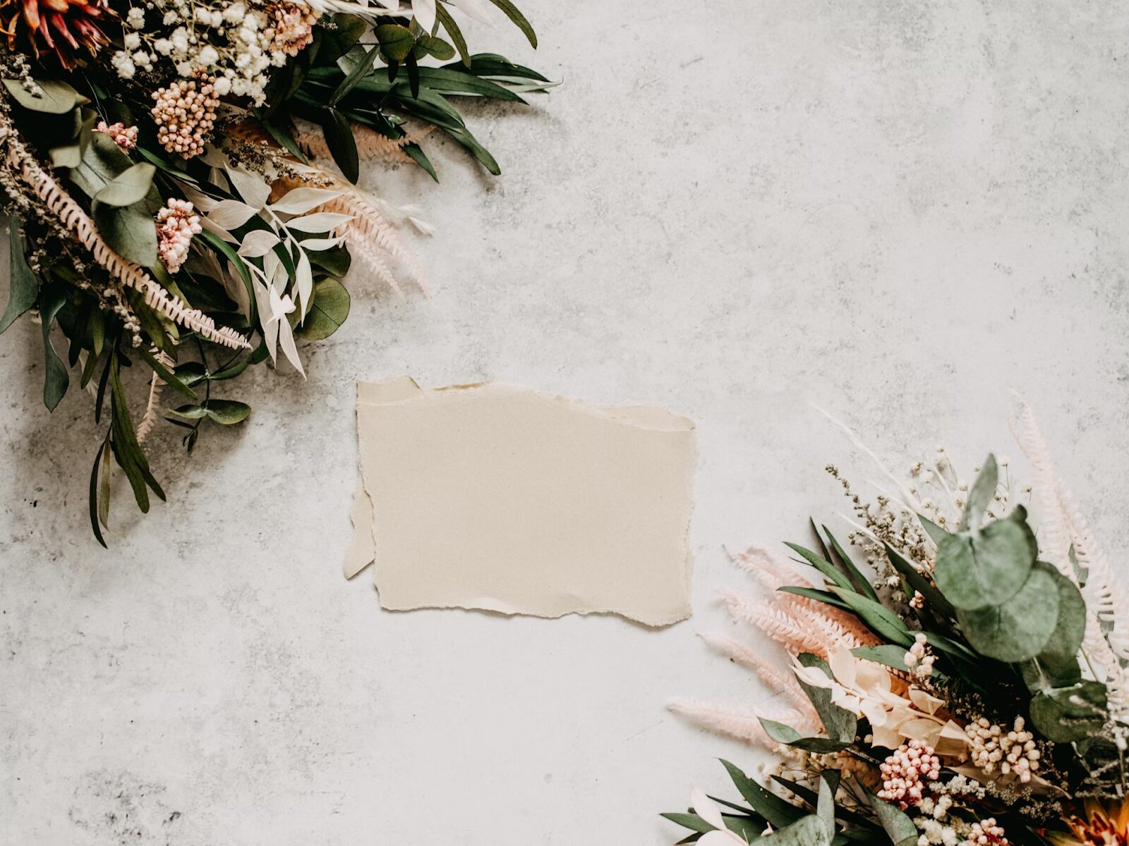 blank piece of paper for wedding invitation and flowers