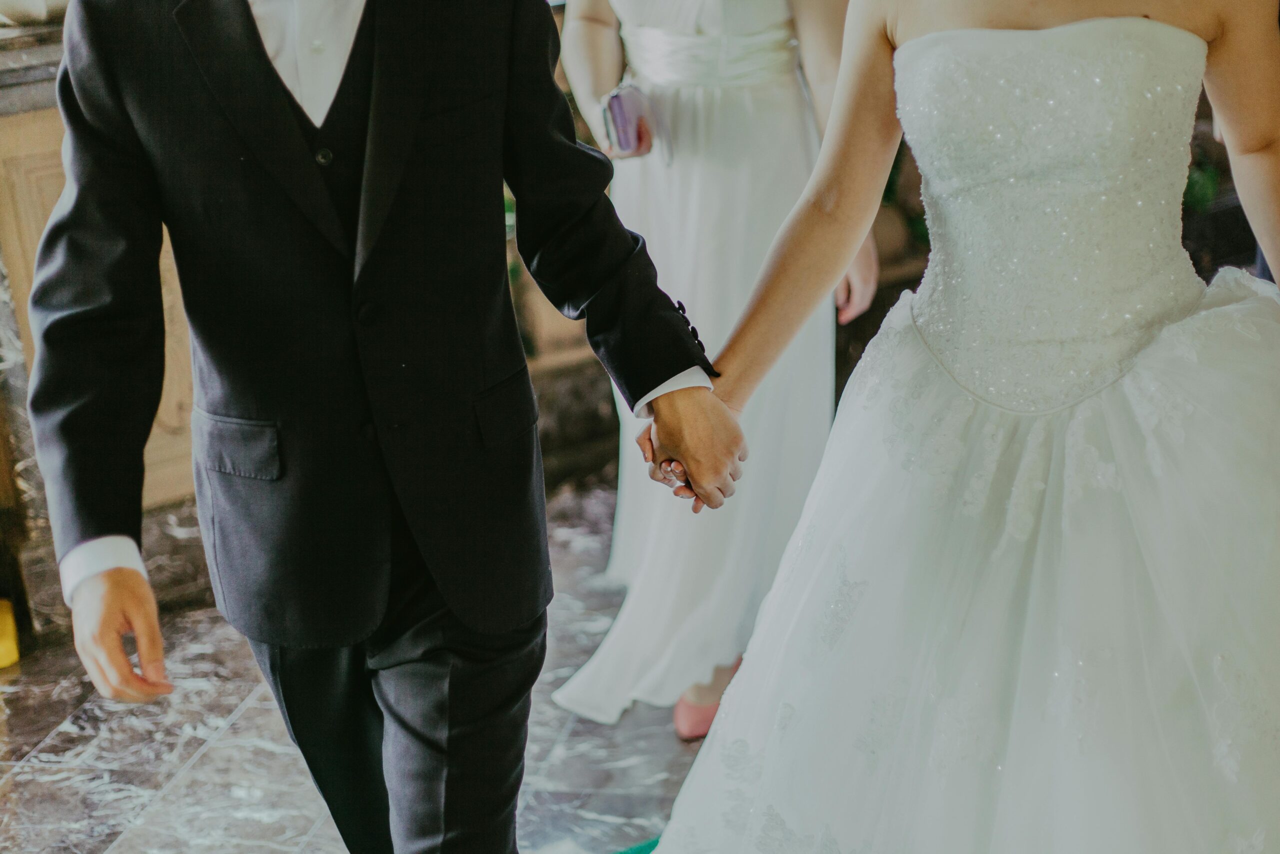 bride and groom holding hands at wedding