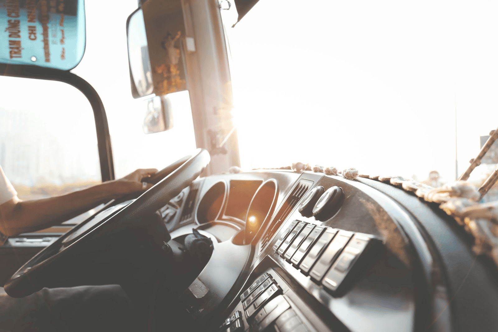 dashboard of a truck with someone holding the steering wheel