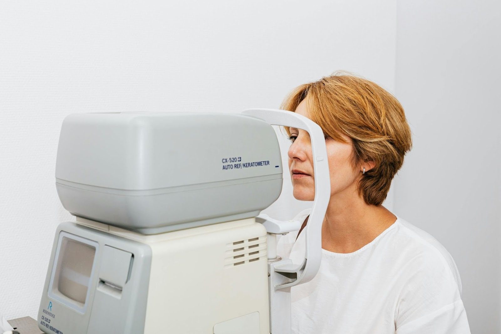 A Woman in White Blouse Having an Eye Examination