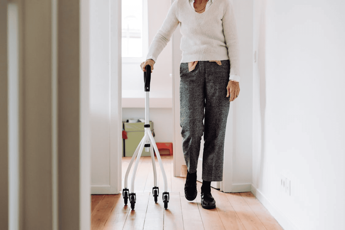 woman walking in house with a walking stand
