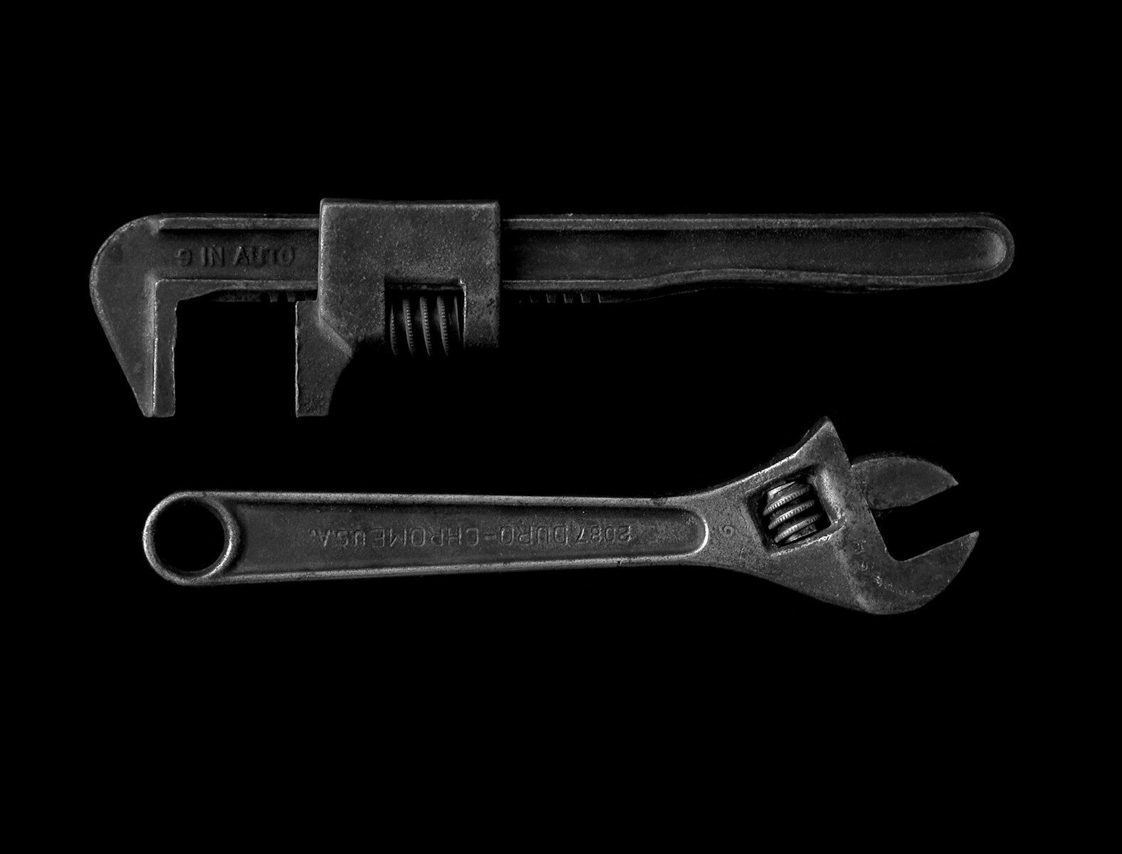 silver adjustable wrench and pipe wrench