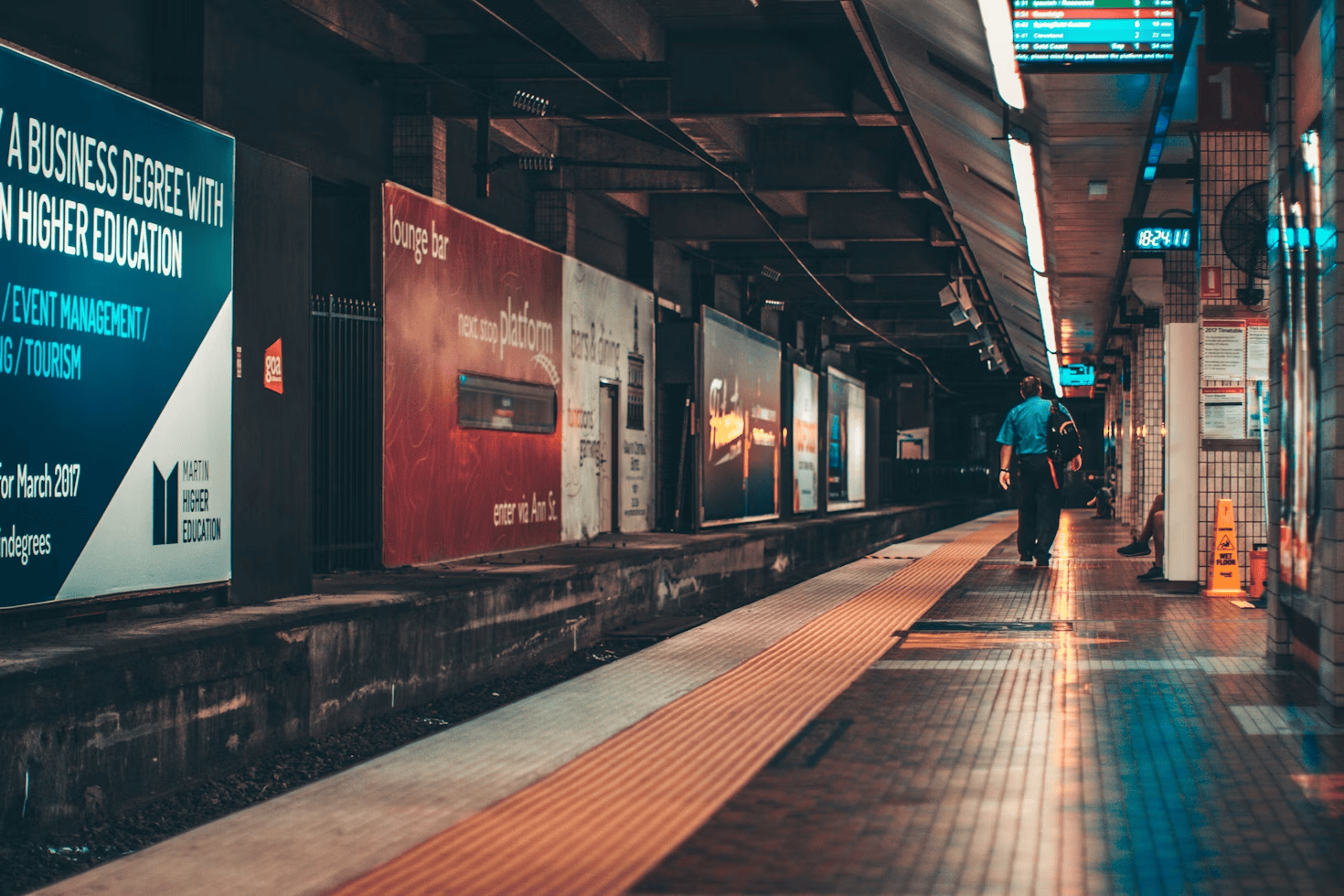 tube station with person walking along platform