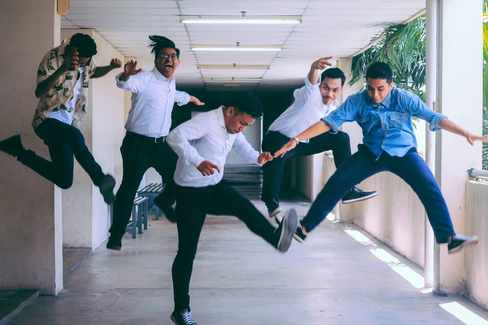 group of men jumping in the air in hallway