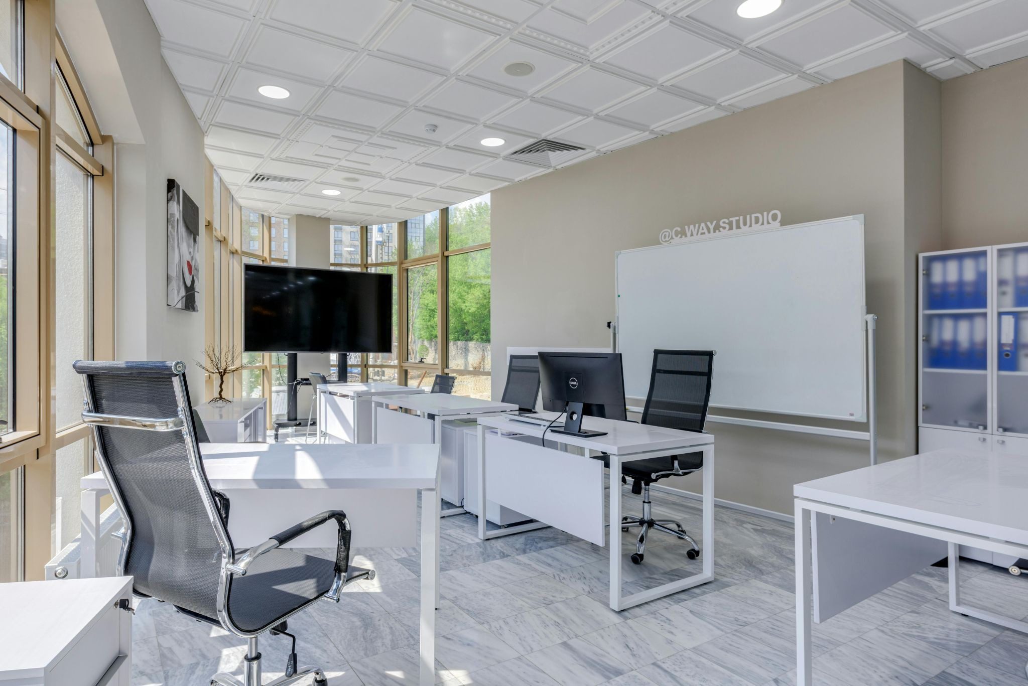 large bright office with white furniture