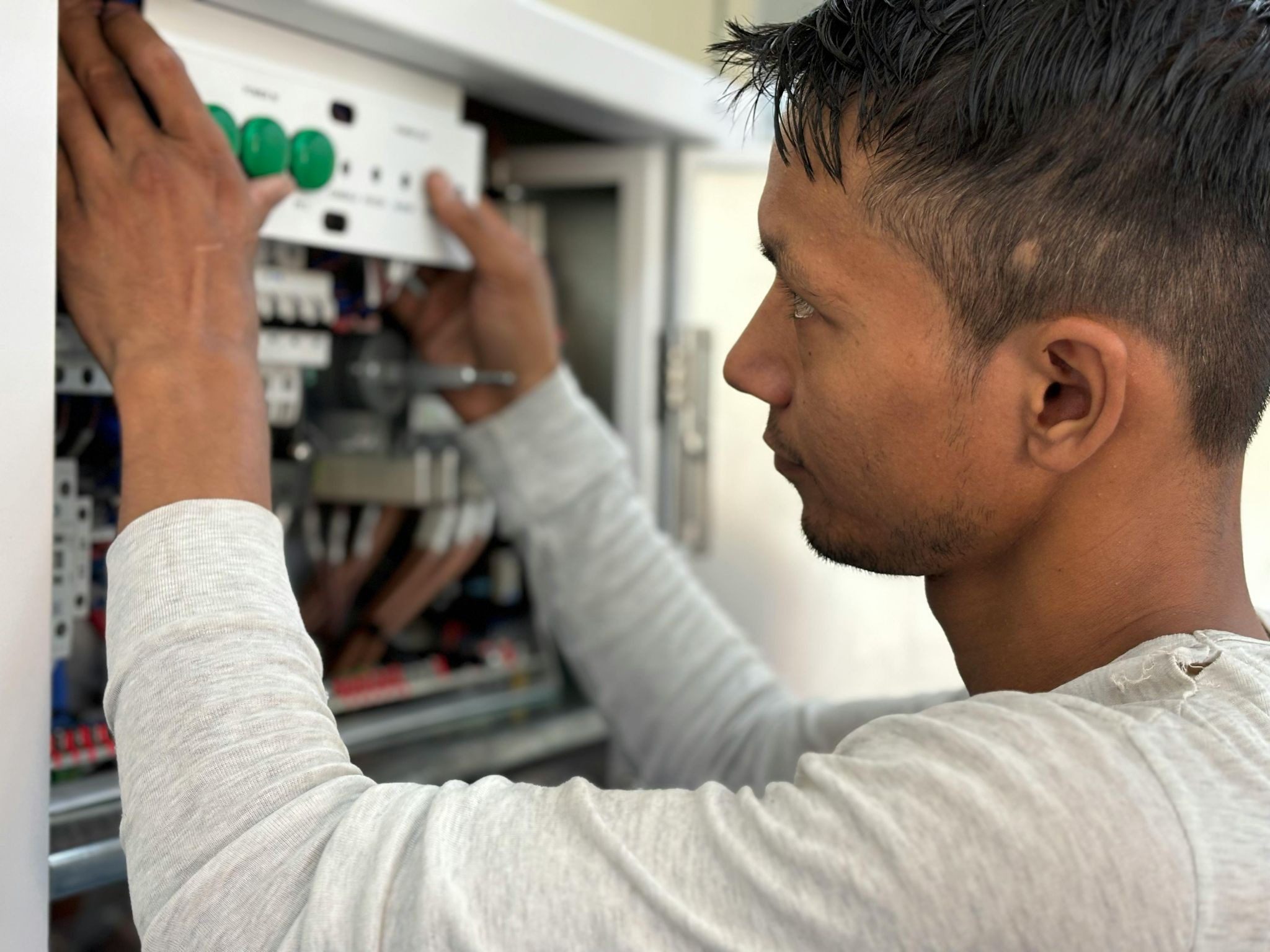 man with hands on electrics