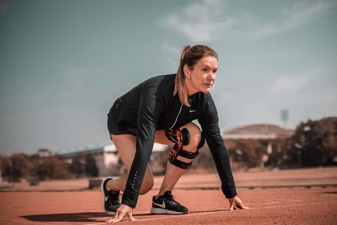 woman outside, in position to start running